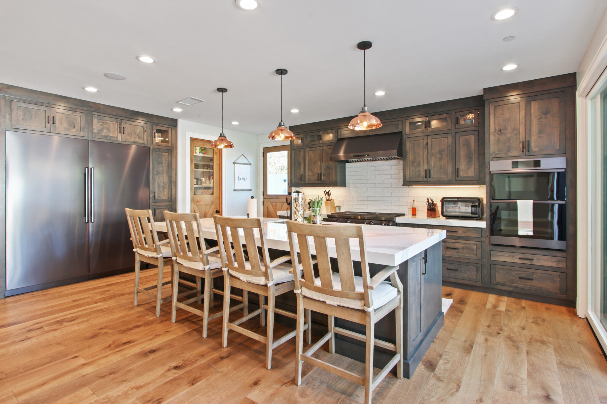 Modern kitchen with dark cabinetry and a central island with seating.