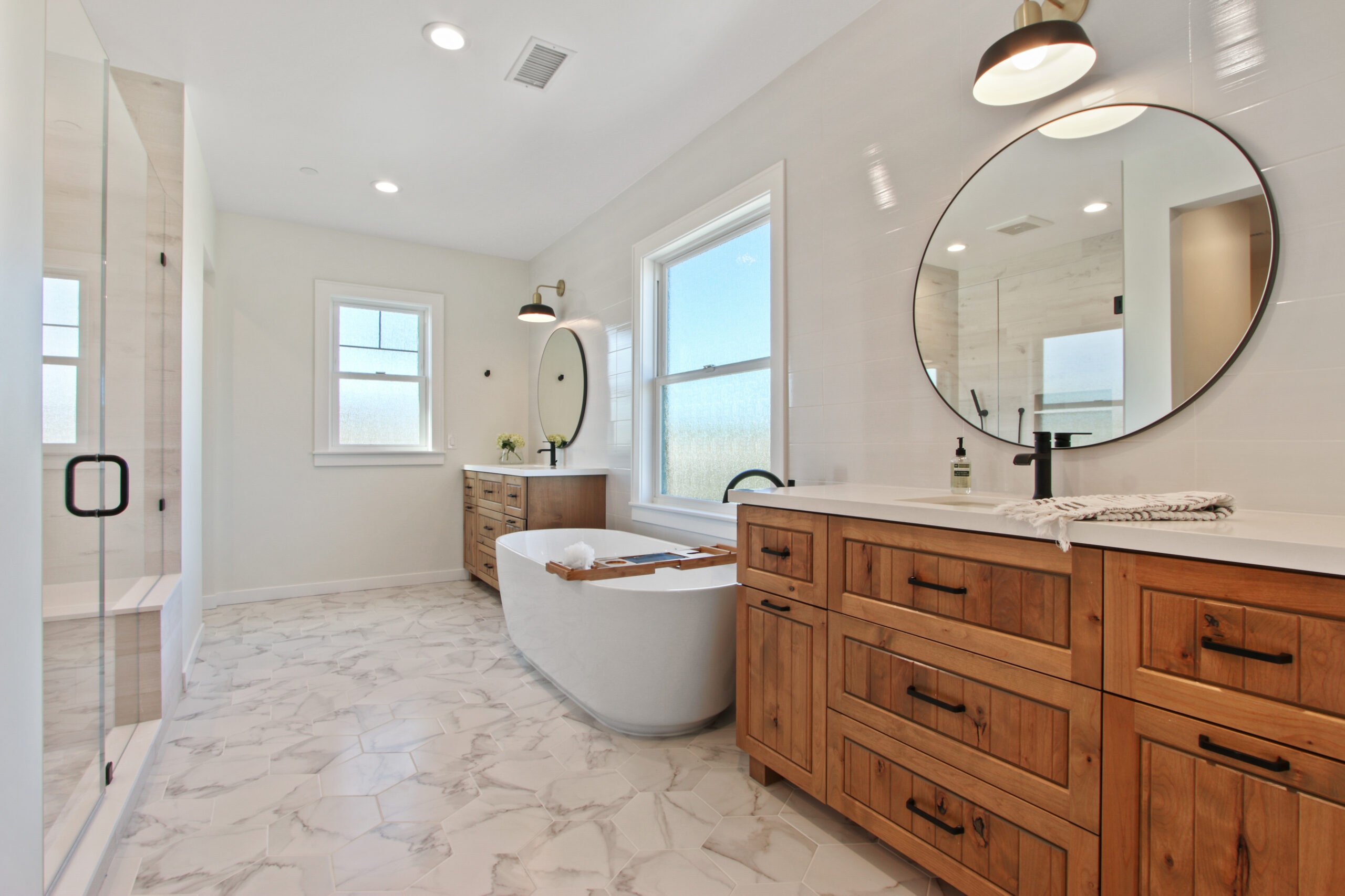 Modern bathroom with a freestanding tub, double vanity, and a walk-in shower.